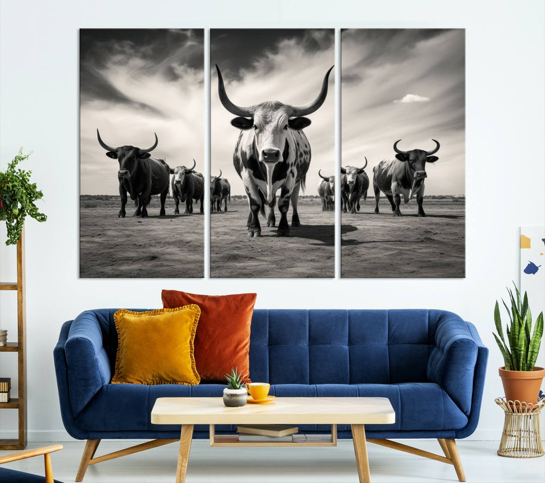 The Black and White Longhorn Cattle Wall Art, featuring a three-panel display of cowboy Western longhorns walking toward the viewer, enhances your space with its striking presence, adding a touch of Western decor.