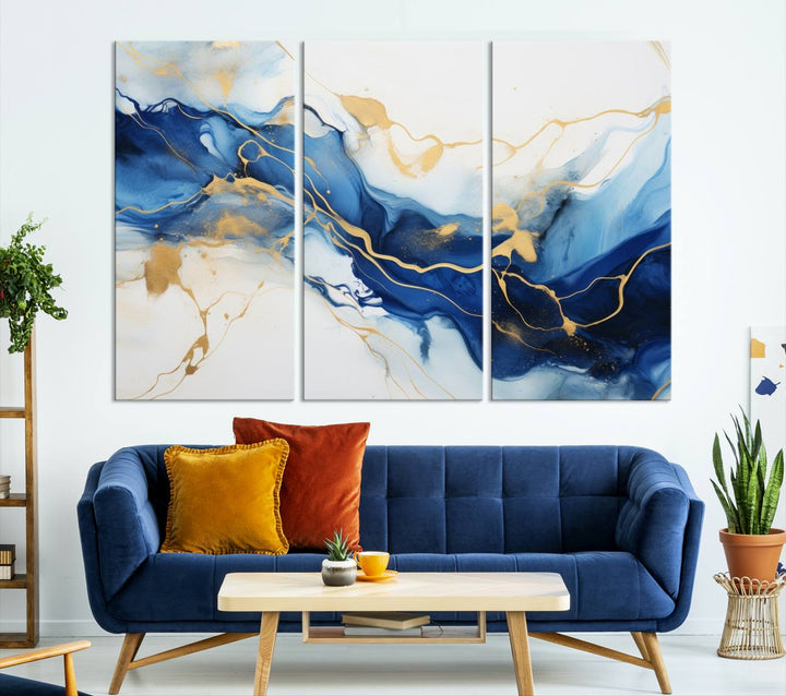 The Blue Abstract Wall Art is displayed as a triptych on museum-quality canvas, showcasing a blue and gold abstract design. The artwork includes a UV-protective coating to maintain its vibrancy and comes with the benefit of free shipping.