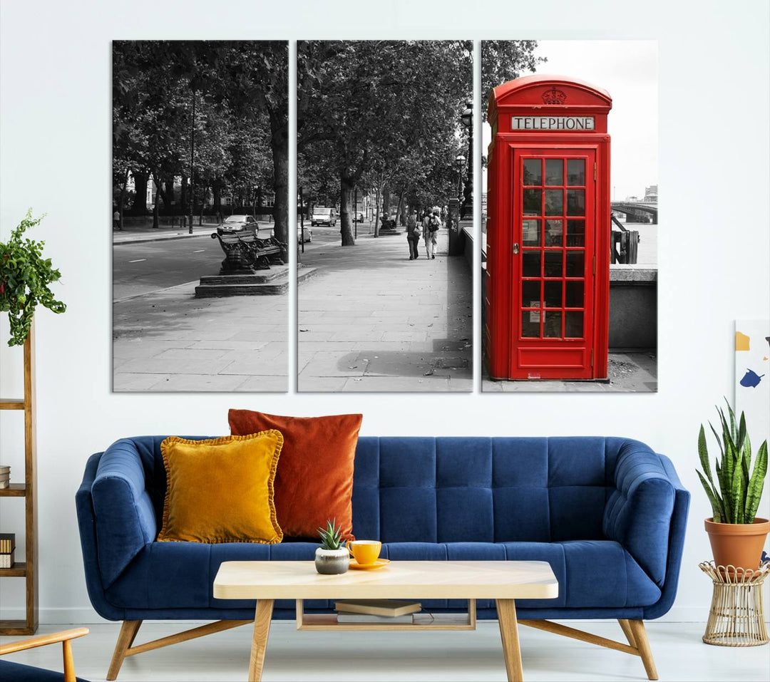 The London Phone Club Wall Art is a stunning piece that showcases a red telephone box set in a black and white street scene on museum-quality canvas. It is gallery wrapped with a UV-protective coating to preserve its vibrant charm.