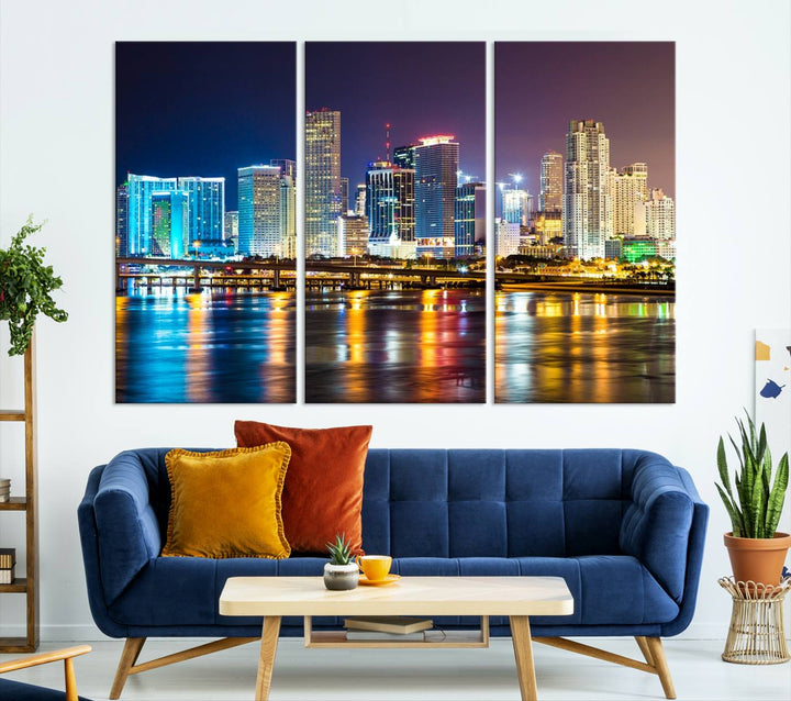 The Wall Art MIAMI Canvas Print features a stunning triptych of a city skyline at night, with vibrant lights reflecting on the water. This gallery-wrapped piece on museum-quality canvas delivers an exquisite finish.