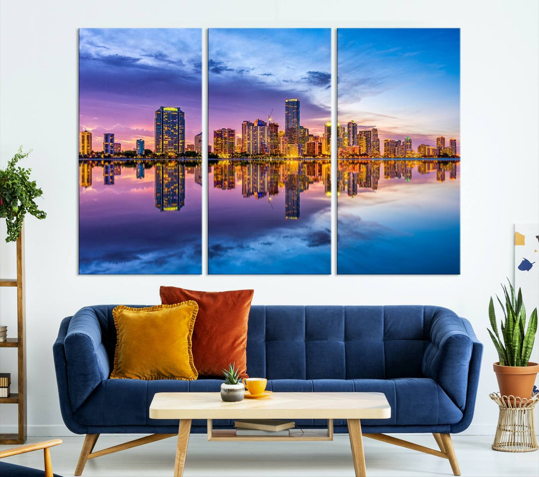 The Miami City Wall Art Canvas Print, featuring a three-panel depiction of a city skyline at sunset reflected in water, beautifully enhances the wall. Made with museum-quality canvas and a UV-protective coating, it comes ready to hang.