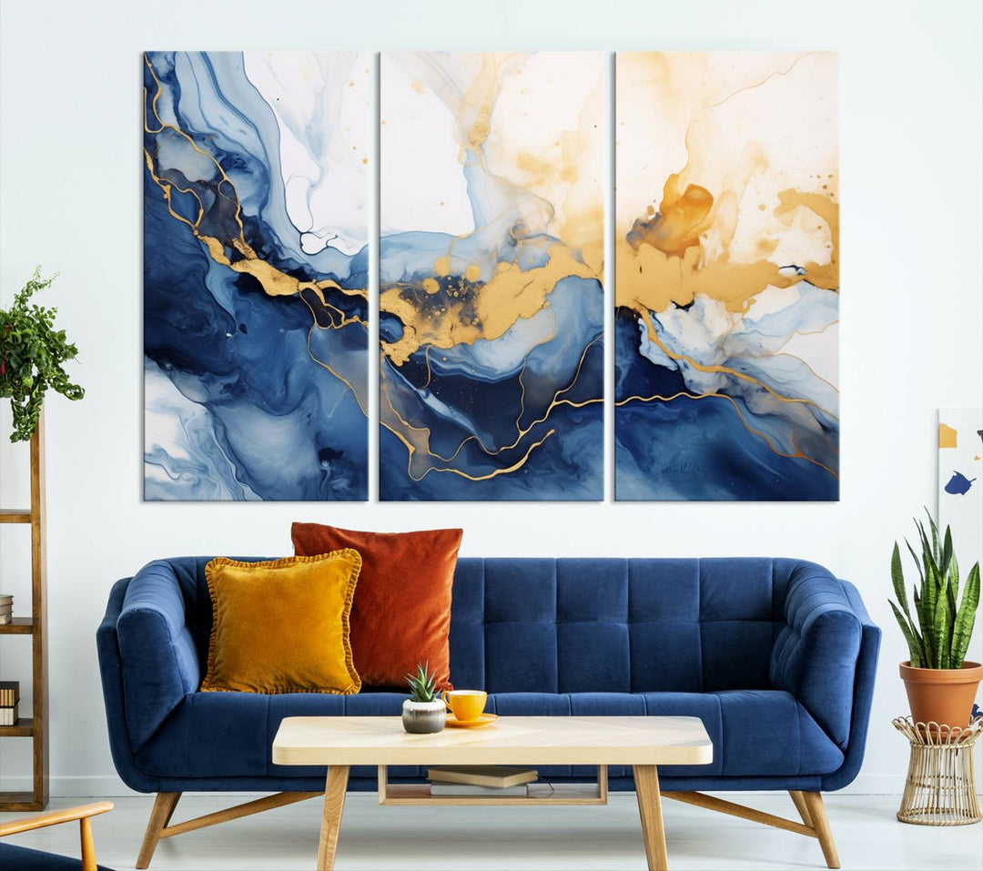 A contemporary living room featuring the "Navy Blue Gold Abstract Wall Art Canvas Print" on the wall, displayed on a gallery-wrapped, museum-quality canvas.