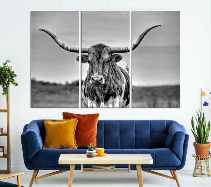 The Texas Longhorn Cow Wall Art, featuring a black and white image of a longhorn bull on canvas, brings charm to the room with its sophisticated appeal.