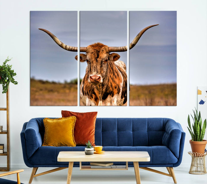 The Texas Longhorn Wall Art Print, a triptych canvas artwork depicting a longhorn bull in a field, features a gallery-quality finish.