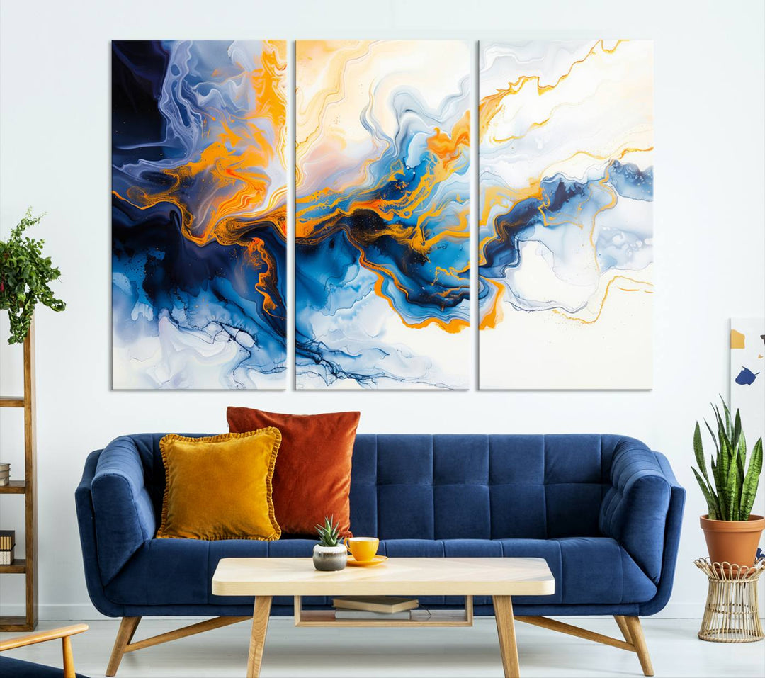 A stunning Fluid Alcohol Ink Wall Art with Gold Wall Art Canvas Print, featuring vibrant blue, orange, and white swirls, adorns the wall. This gallery-quality finish adds an exquisite touch to any living space.