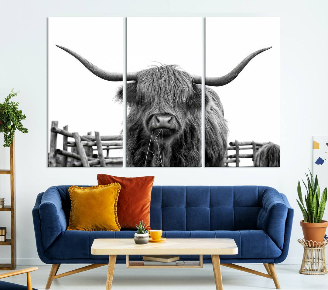 The Longhorn Canvas Print, featuring a black-and-white triptych of a Bighorn cow with shaggy fur and impressive long horns, is elegantly showcased. This wall art piece boasts a gallery-quality finish on premium canvas, bringing sophistication to any room.