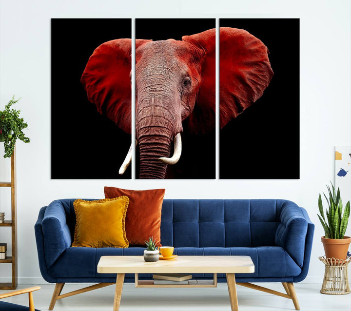 A Wall Art Canvas Print in the modern living room features a three-panel premium design of a red elephant face.