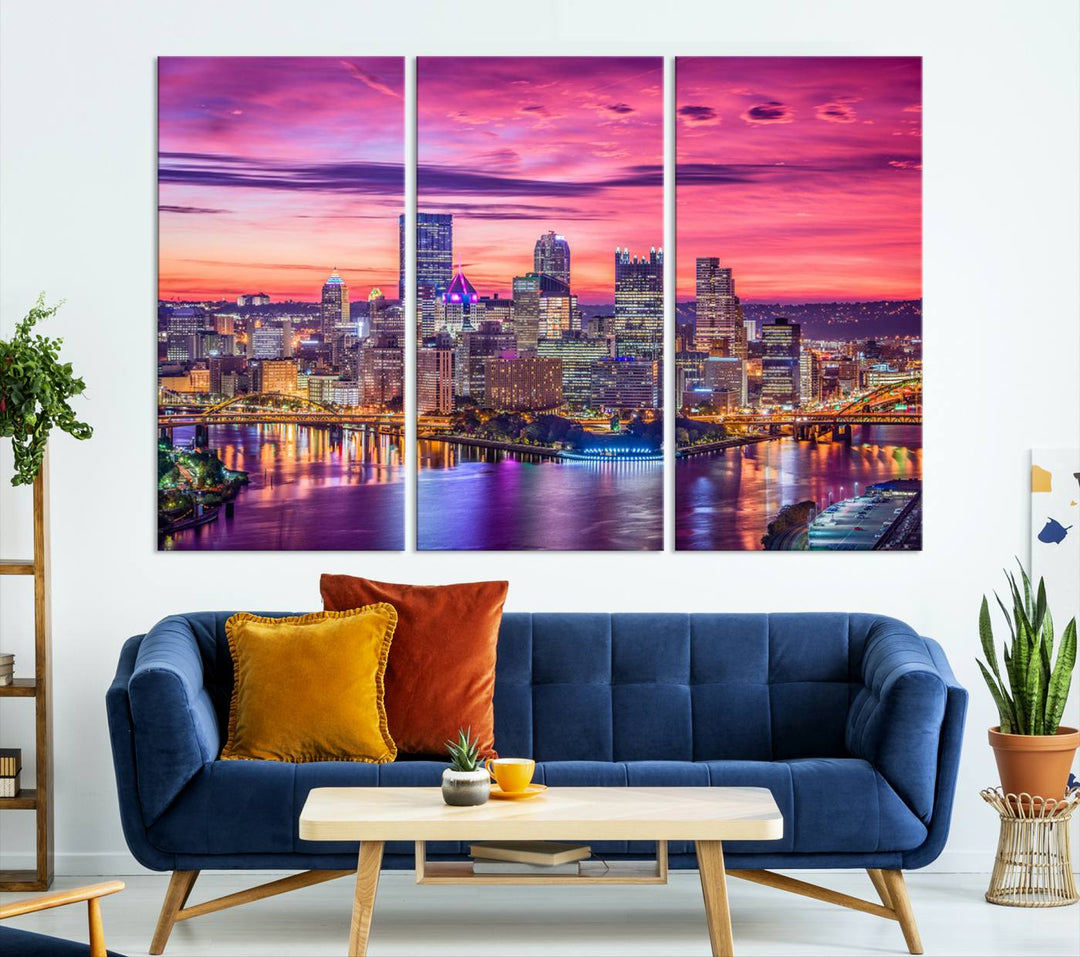 The Pittsburg Wall Art Canvas Print, showcasing a vibrant sunset glow over the city skyline and crafted by a professional artisan, adorns the space.