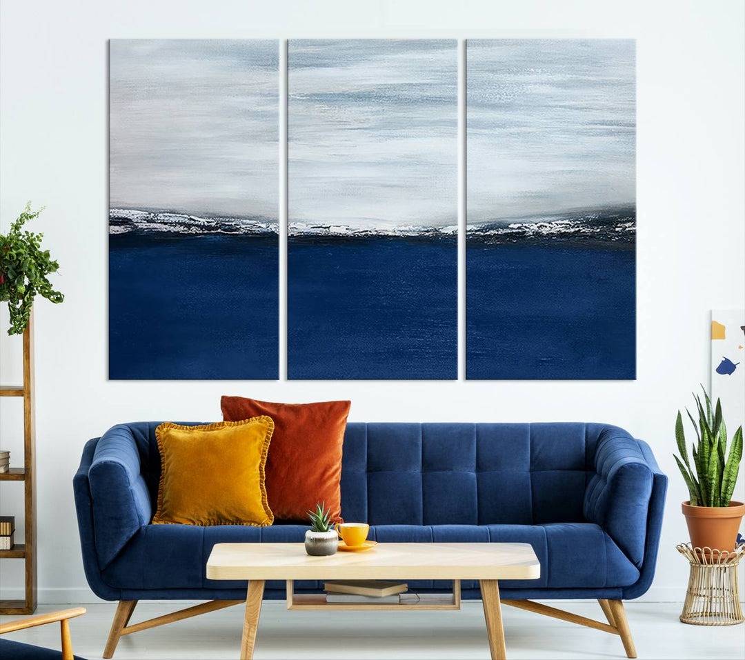 The modern living room is enhanced by the Navy Blue Abstract Wall Art Canvas Print on the wall, crafted as handmade wall art with a gallery-quality finish.