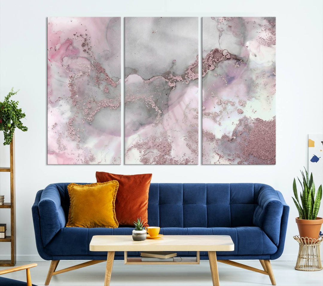 The Rose Marble Abstract Wall Art Canvas Print is a stunning triptych that showcases pink and gray tones, elegantly presented on a dark wall.