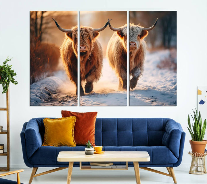 The living room showcases a triptych from the Scottish Highland Cow Horn Farm Wall Art Canvas Print collection, depicting two Highland cows running in the snow. Complementing this are handmade wall art pieces with a gallery-quality finish that add an elegant touch.