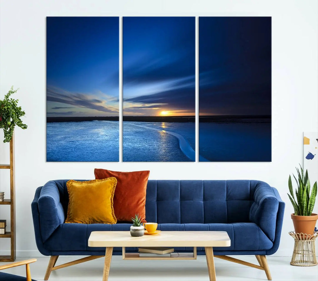 The living room features a triptych of the Wall Art Canvas Print Navy Sunset Lake Landscape Artwork, adding to its tranquil vibe.