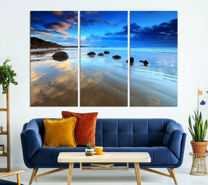 An elegant triptych artwork titled "Wonderful Beach Landscape with Mountain," beautifully displayed on museum-quality canvas, enhances the stylish living room.