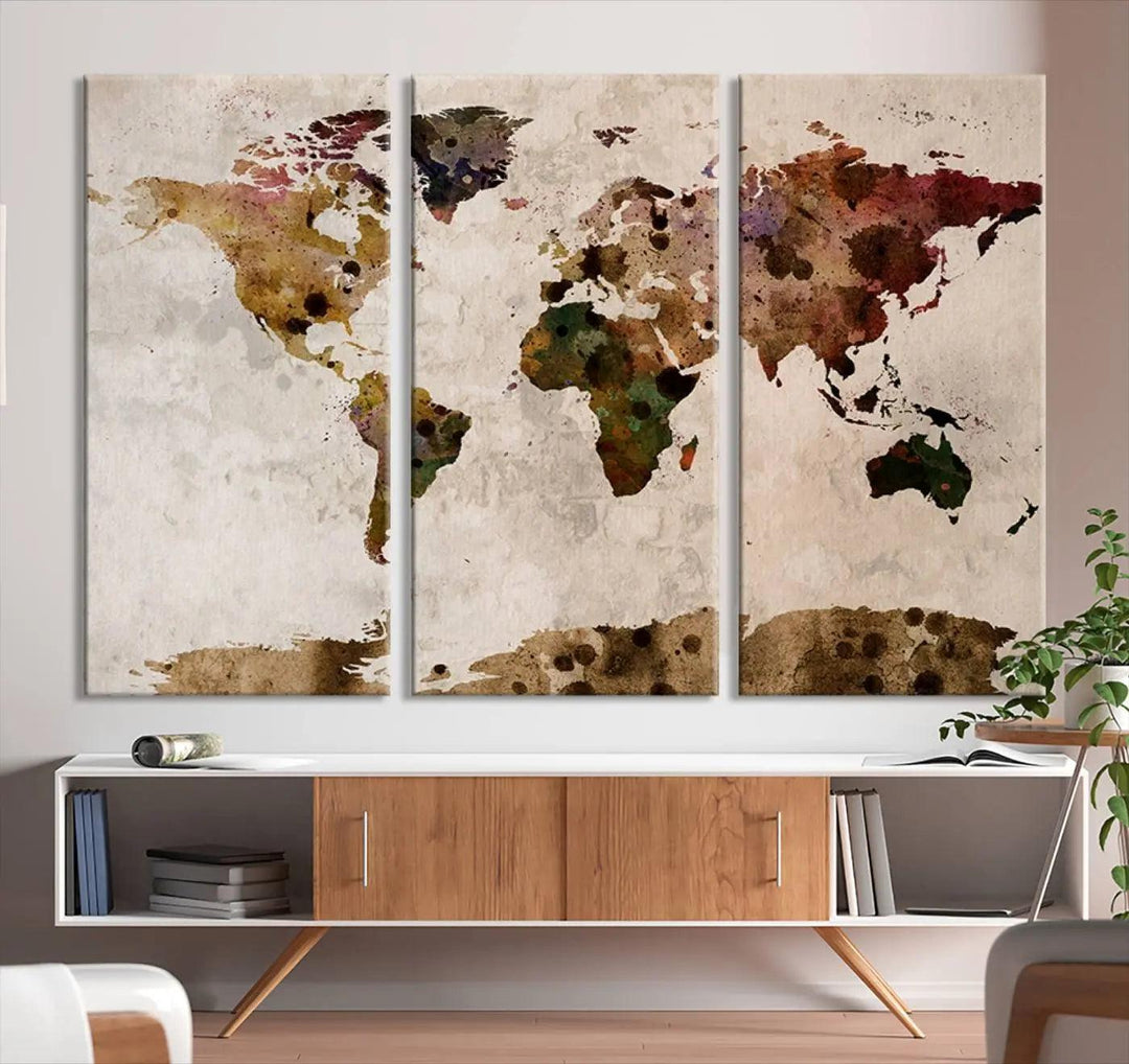 A Watercolor World Map Canvas Print, wrapped in an elegant gallery style, hangs on the wall.