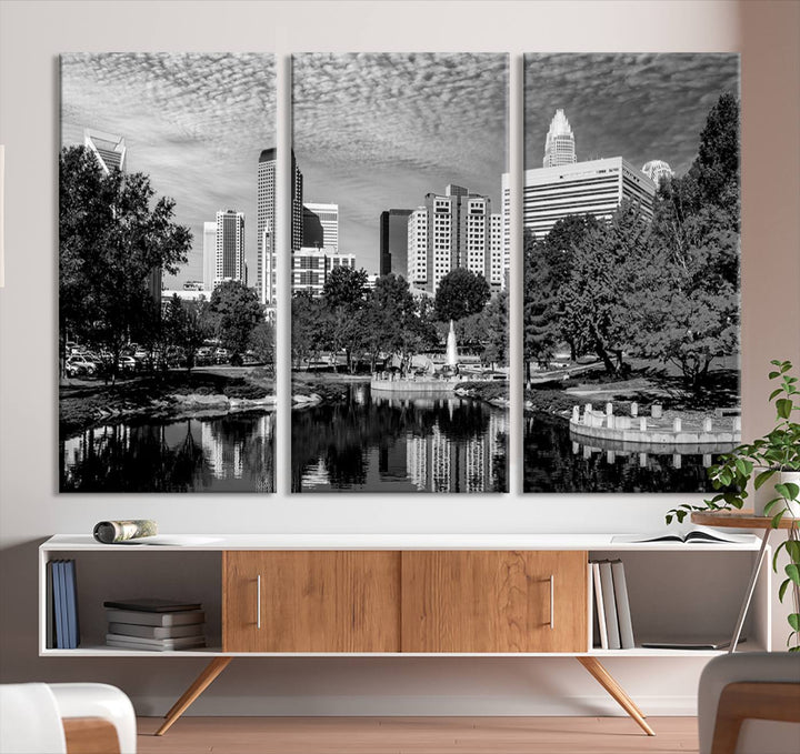 The living room features a captivating triptych titled "Charlotte City Cloudy Skyline Black and White Wall Art Cityscape Canvas Print," crafted on museum-quality canvas with UV-protective coating. Modern decor accentuates the dynamic scene.