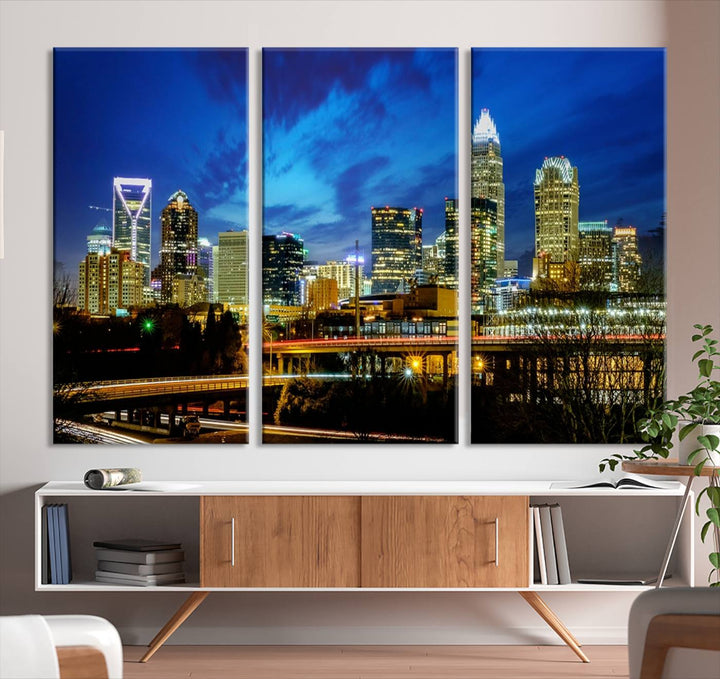 A modern living room highlighted by the "Charlotte City Lights Cloudy Blue Night Skyline Cityscape View" wall art canvas print, crafted on museum-quality canvas with UV-protective coating.