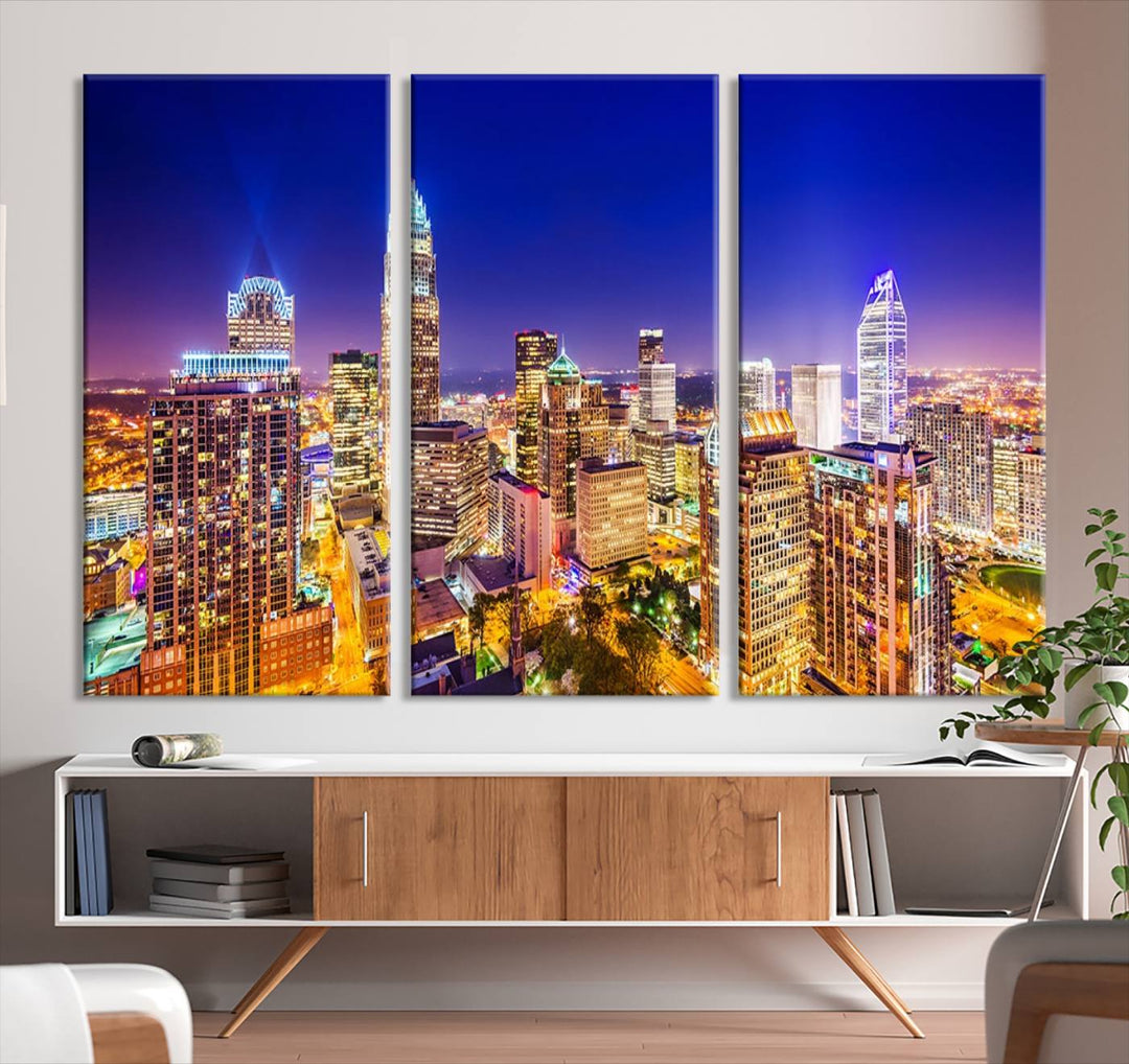 A modern living room features the Charlotte City Lights Night Blue Skyline Cityscape View wall art canvas print.