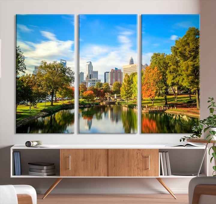 The Charlotte City Park at Spring Skyline Cityscape View wall art canvas print is a triptych featuring a scenic park with a lake and city skyline. It is gallery-wrapped on museum-quality canvases.