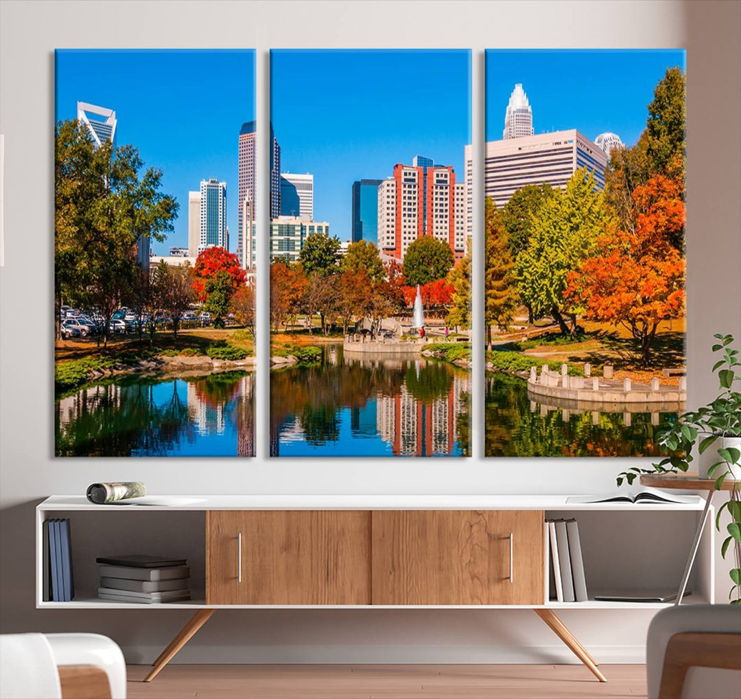 The Charlotte City Park at Fall Skyline Cityscape View wall art canvas print features a city panorama with a park and lake accented by autumn trees. It is mounted on museum-quality canvas with UV-protective coating and decorates the space.