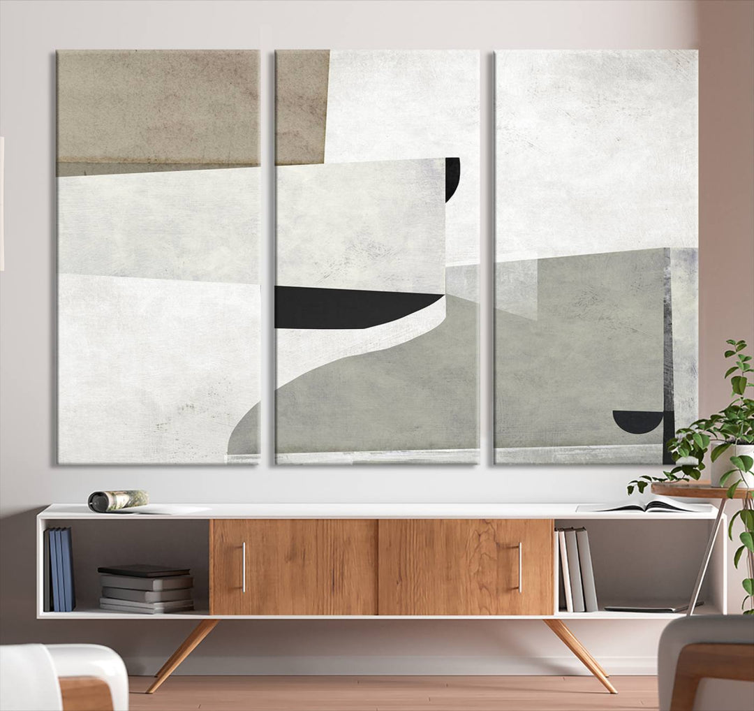 The Brown Gray Figures Abstract Wall Art Canvas Print is displayed as a triptych on a dark wall. The piece is gallery wrapped, offering a seamless finish and enhanced durability due to its UV-protective coating.