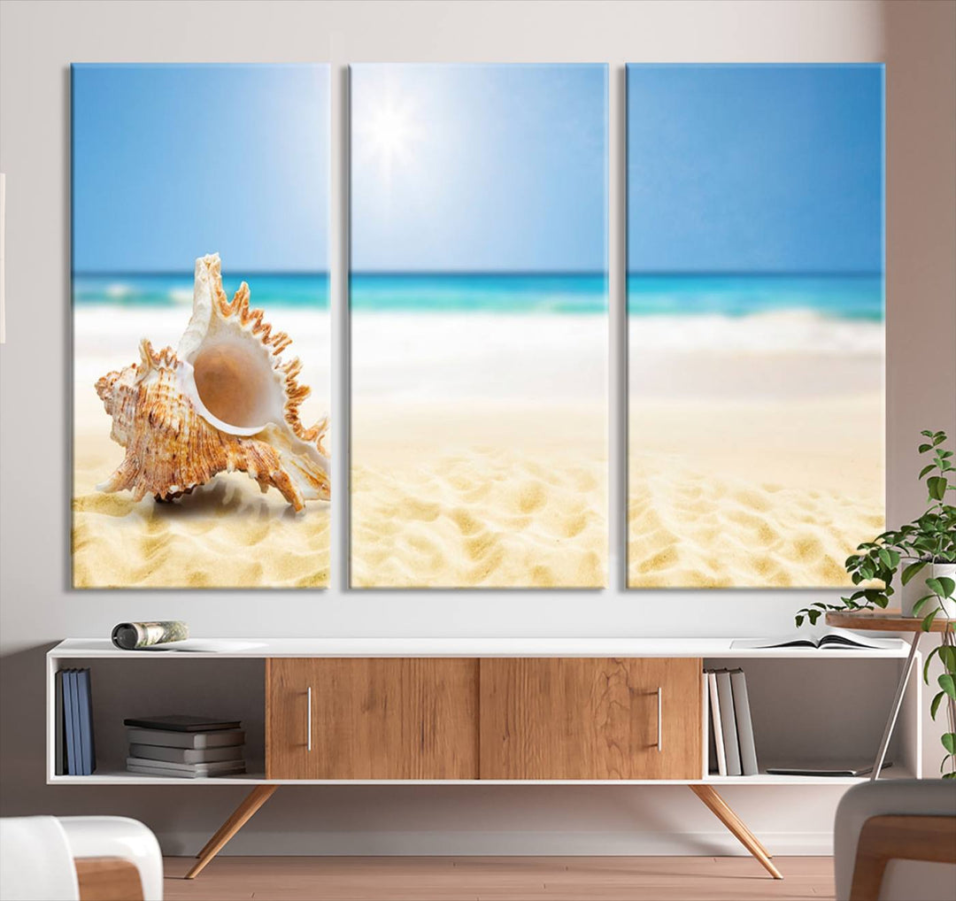 The Sea Shell on The Beach Sun Sand Wall Art Canvas Print is a triptych that beautifully captures a beach scene with a large seashell on the sand.