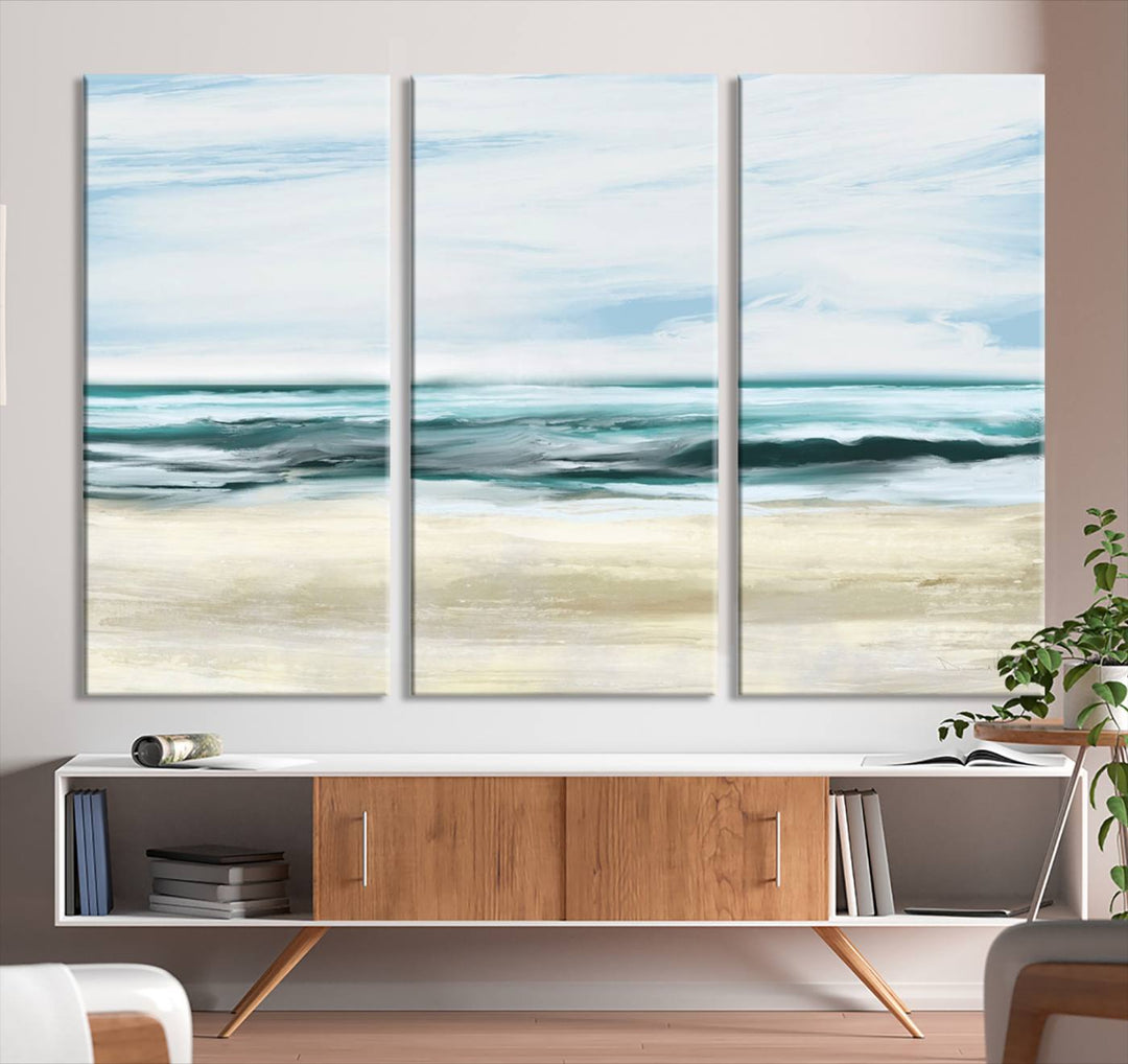 The room features the Ocean Abstract Wall Art Canvas Print, a triptych beach painting on museum-quality canvas with a gallery-wrapped finish and UV-protective coating.