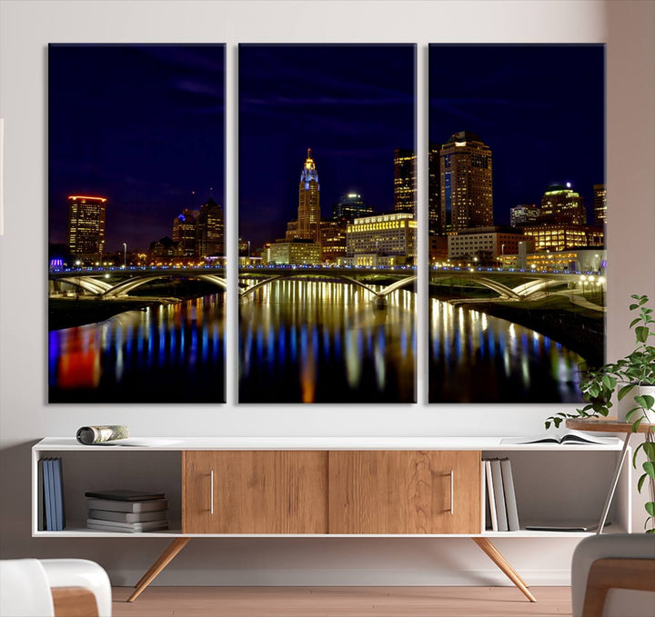 The "Columbus City Lights Night Skyline Cityscape View Wall Art Canvas Print" showcases a stunning city skyline at night, with illuminated buildings and bridges reflecting in the river, on a museum-quality canvas ready to hang.