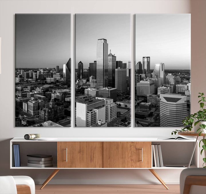 A modern living room showcases the Dallas City Lights Skyline Black and White Wall Art Cityscape Canvas Print. This gallery-wrapped piece offers a sleek finish and is crafted from museum-quality pollycotton. It features a UV-protective coating to ensure lasting vibrancy.