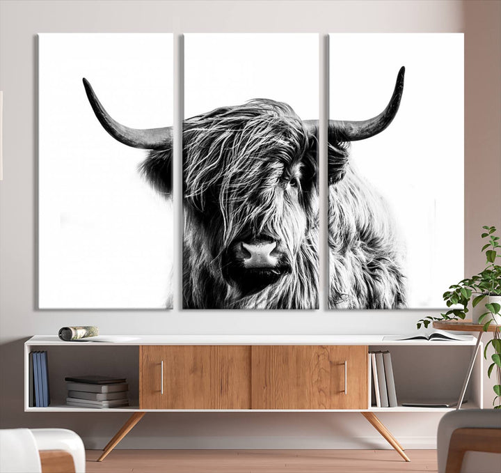 The Scottish Highland Cow Cattle Art Print Farmhouse Wall Art Canvas Print enhances rustic farmhouse decor with its depiction of a long-haired, large-horned cow. This triptych is an ideal choice for chic wall art.