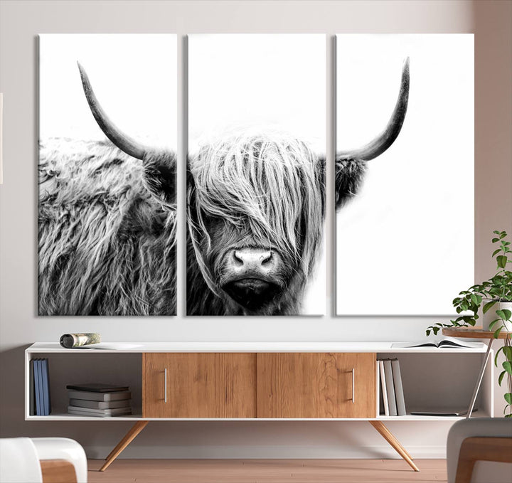 A museum-quality triptych titled "Black White Scottish Highland Cow Cattle Art Print Farmhouse Wall Art Canvas Print" embellishes the dark wall. The canvas is equipped with a UV-protective coating to ensure lasting vibrancy.