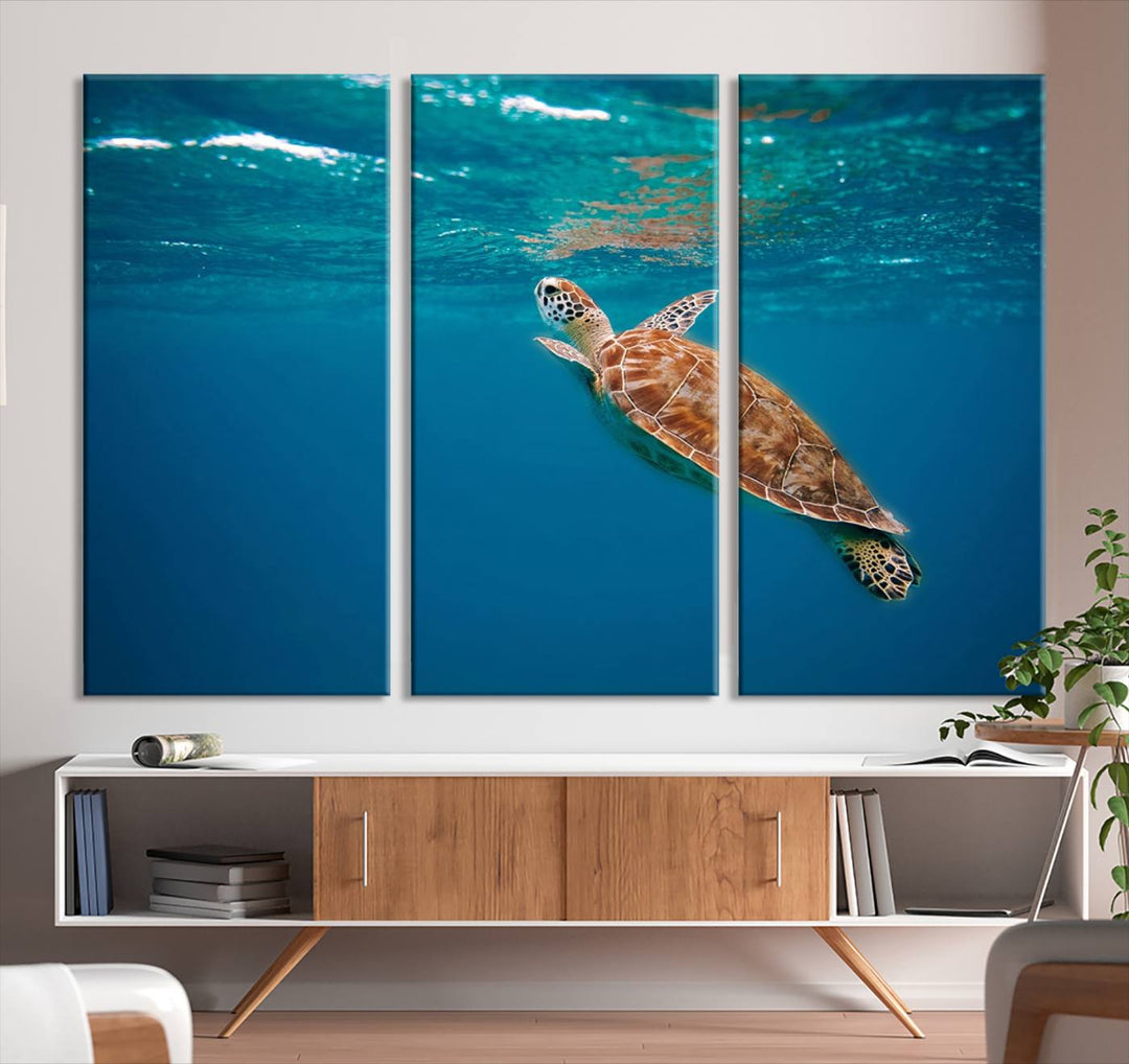 The living room features the "Baby Turtle in Ocean" wall art canvas print. This gallery-quality piece, depicting a sea turtle swimming underwater, adds an elegant touch to the space.