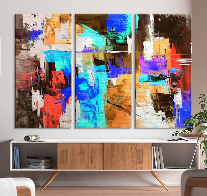 In a modern living room, the "Colorful Abstract Wall Art Canvas Print" serves as a stunning triptych centerpiece on museum-quality canvas, ready to hang. Its UV-protective coating ensures enduring vibrancy.