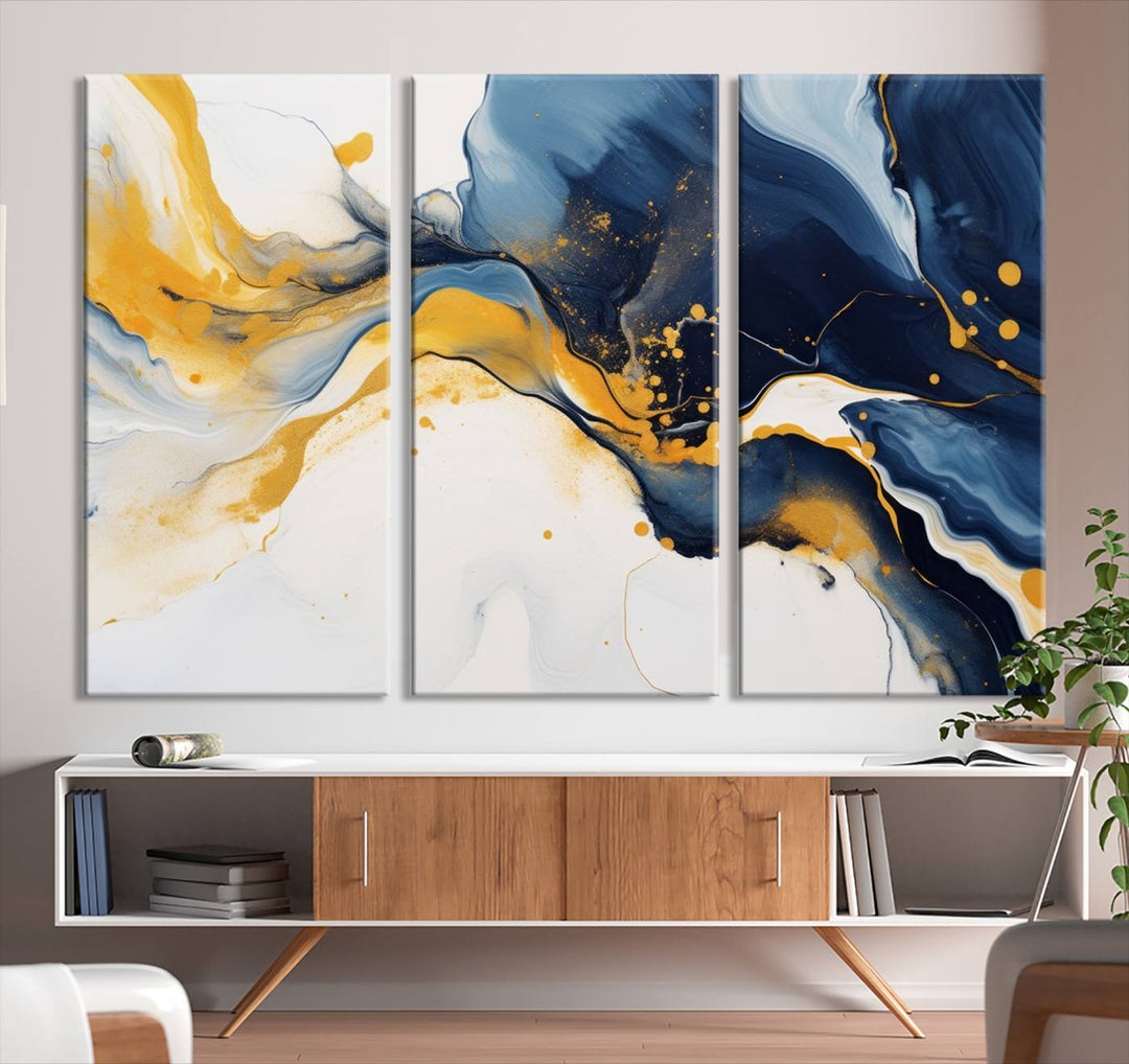 The Blue and Gold Abstract Fluid Canvas Art, with its swirling patterns, adorns the wall. This modern wall art beautifully complements the contemporary interior decor, adding an elegant touch with its rich blue, gold, and white tones.