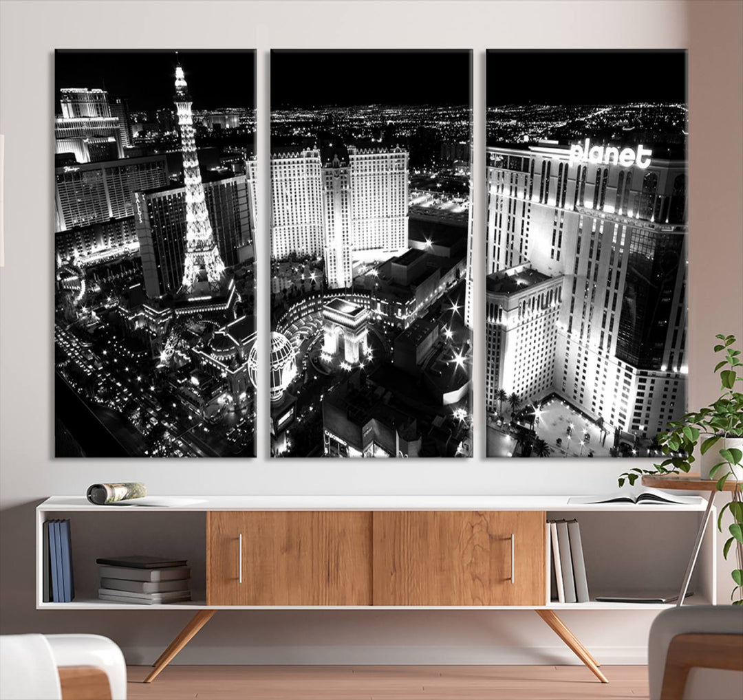 The Las Vegas Wall Art Canvas Print is a black and white triptych that showcases a city skyline at night. Crafted on museum-quality canvas with a UV-protective coating, it serves as an elegant and ready-to-hang focal point in the room.