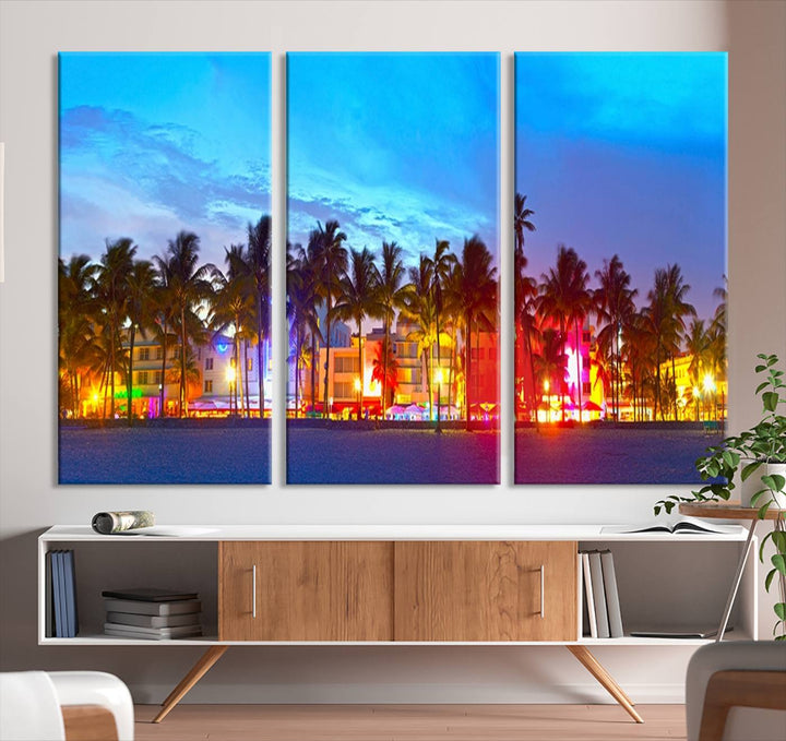 The living room features a three-panel Miami City Wall Art Canvas Print, showcasing a colorful, illuminated beach scene with palm trees on museum-quality canvas.