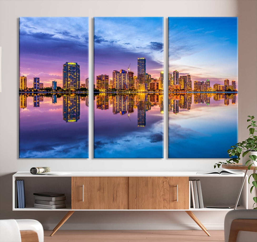 The Miami City Wall Art Canvas Print, featuring a three-panel depiction of a city skyline at sunset reflected in water, beautifully enhances the wall. Made with museum-quality canvas and a UV-protective coating, it comes ready to hang.