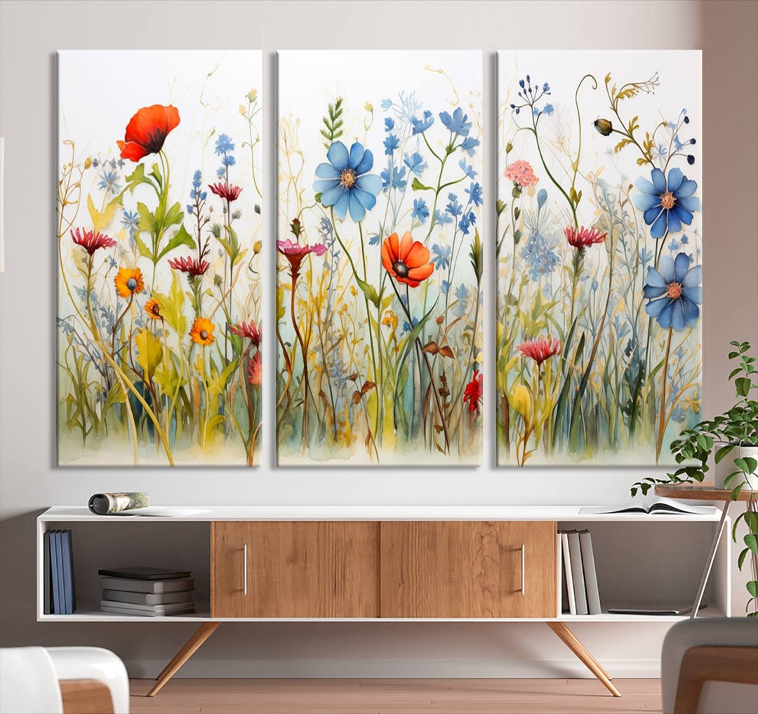 The Colorful Wildflower Canvas Wall Art – Vibrant Floral Botanical Print, consisting of a large 3 panel set, adds bright nature decor to the living room against a black wall.