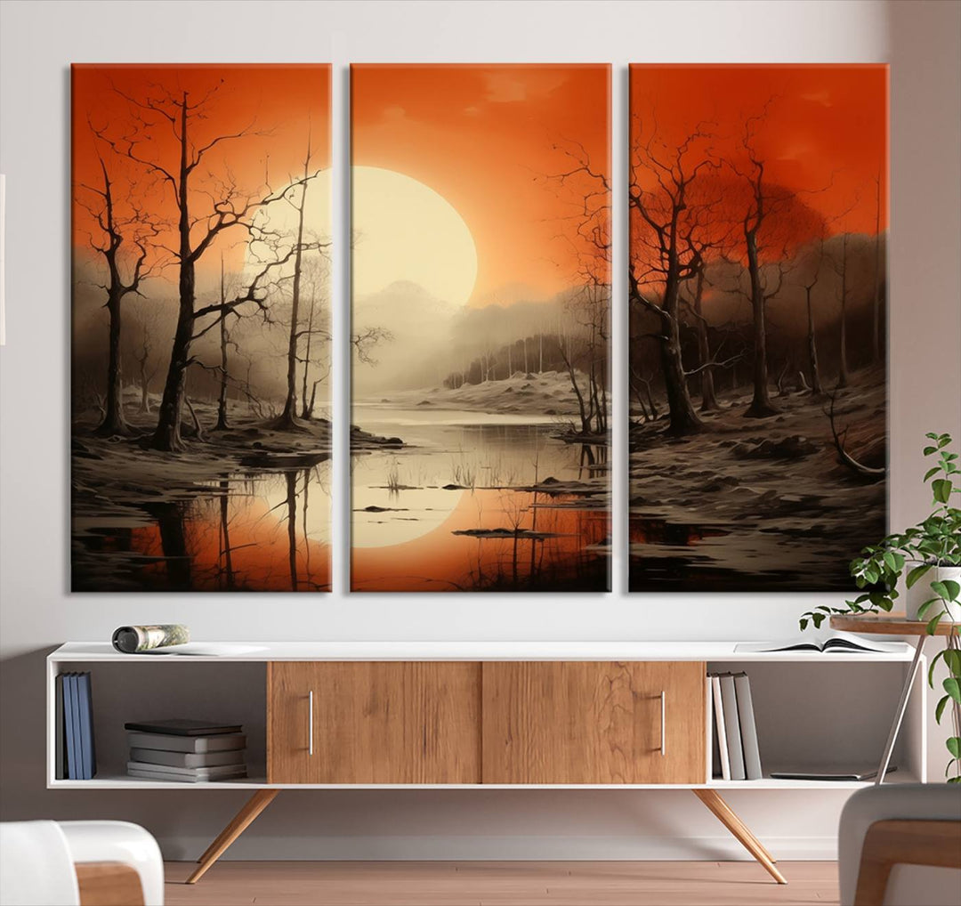 The "Abstract Watercolor Trees and Sunset on Lake Wall Art" is a triptych masterpiece, showcasing an orange-hued landscape of barren trees and a large sun. Displayed on museum-quality canvases with UV-protective coating, it creates a striking visual element in any space.