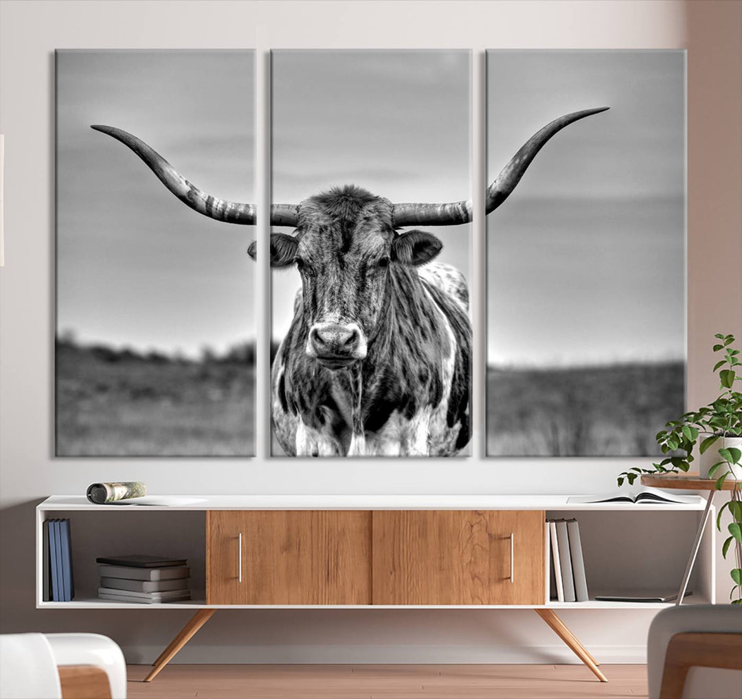 The Texas Longhorn Cow Wall Art, featuring a black and white image of a longhorn bull on canvas, brings charm to the room with its sophisticated appeal.