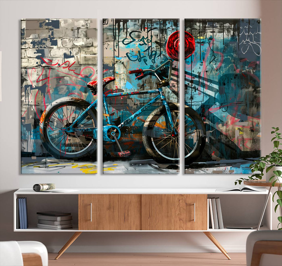 A modern living room features a triptych wall art of an abstract bicycle, designed in a graffiti style on a brick wall. This piece is expertly crafted on the Abstract Bicycle Wall Art Canvas Print, offering a premium canvas that ensures a gallery-quality finish.