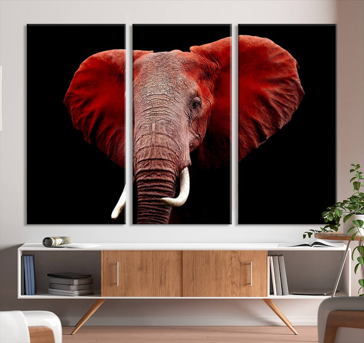 A Wall Art Canvas Print in the modern living room features a three-panel premium design of a red elephant face.