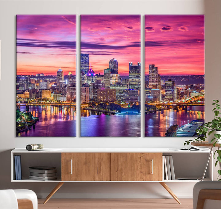 The Pittsburg Wall Art Canvas Print, showcasing a vibrant sunset glow over the city skyline and crafted by a professional artisan, adorns the space.