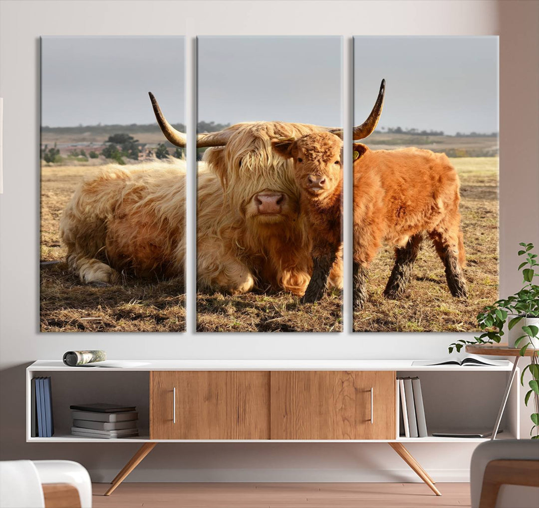 The three-panel canvas artwork, titled "Highland Cow Canvas Wall Art Animal Print for Farm House Decor," features a serene scene of a resting Highland cow and calf in a field. The piece highlights its gallery-quality finish.