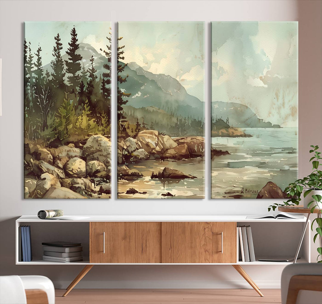 The living room features a breathtaking three-panel Abstract Acadia National Park Wall Art Canvas Print, which beautifully captures the rocky Maine coastline with trees and mountains.