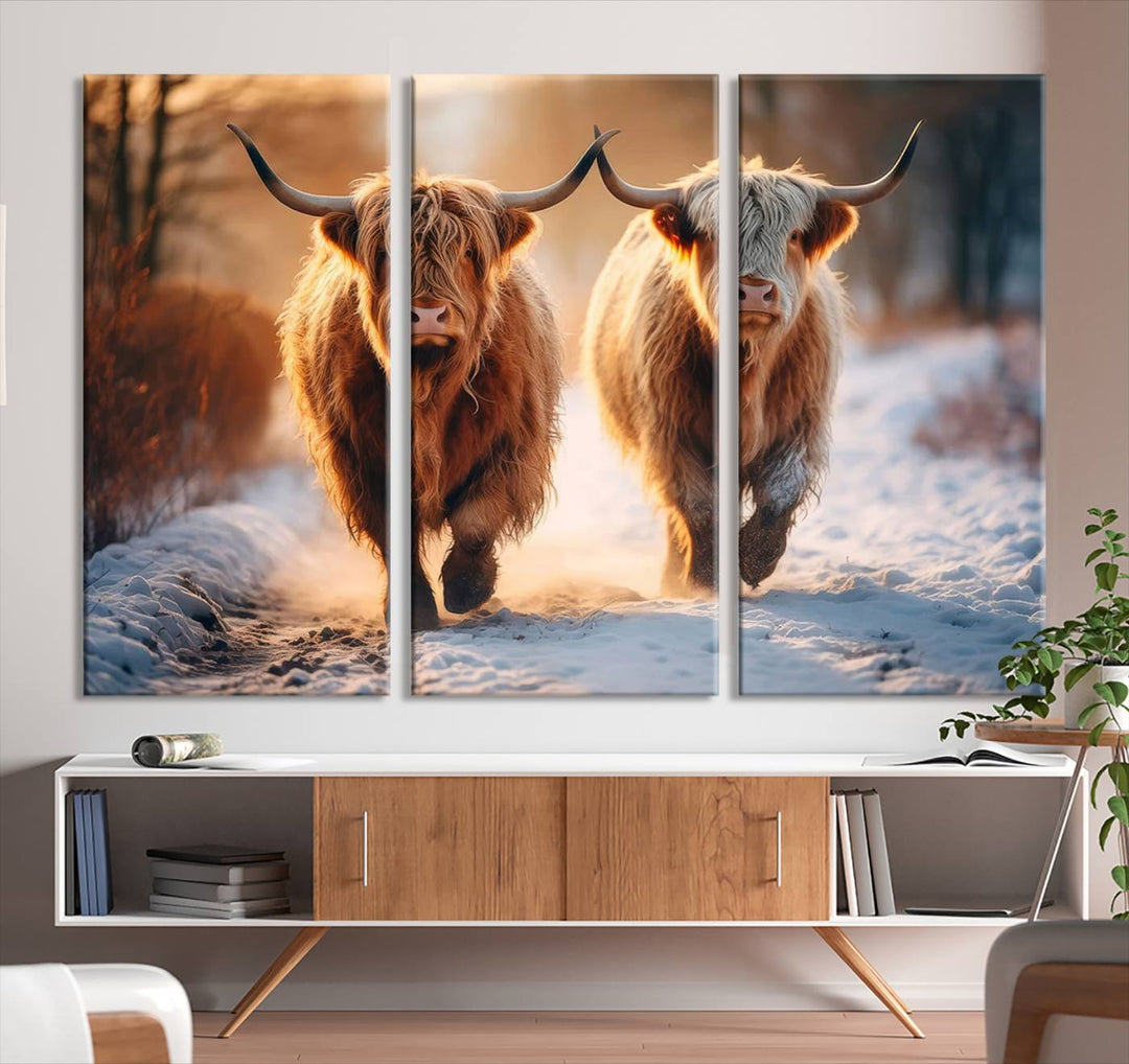 The living room showcases a triptych from the Scottish Highland Cow Horn Farm Wall Art Canvas Print collection, depicting two Highland cows running in the snow. Complementing this are handmade wall art pieces with a gallery-quality finish that add an elegant touch.