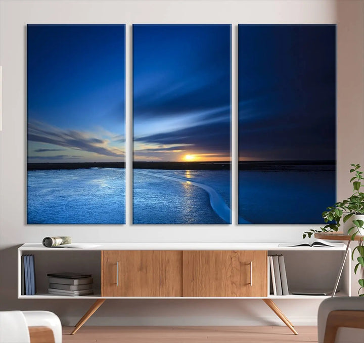 The living room features a triptych of the Wall Art Canvas Print Navy Sunset Lake Landscape Artwork, adding to its tranquil vibe.