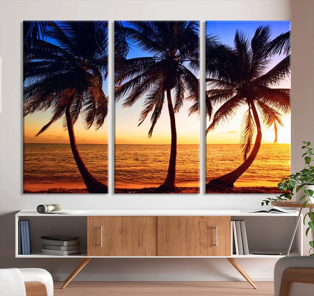 The living room features a wall adorned with the "Wall Art Canvas Curve Palms at Sunset on Beach," showcasing gallery-wrapped, museum-quality canvases in a stunning triptych.