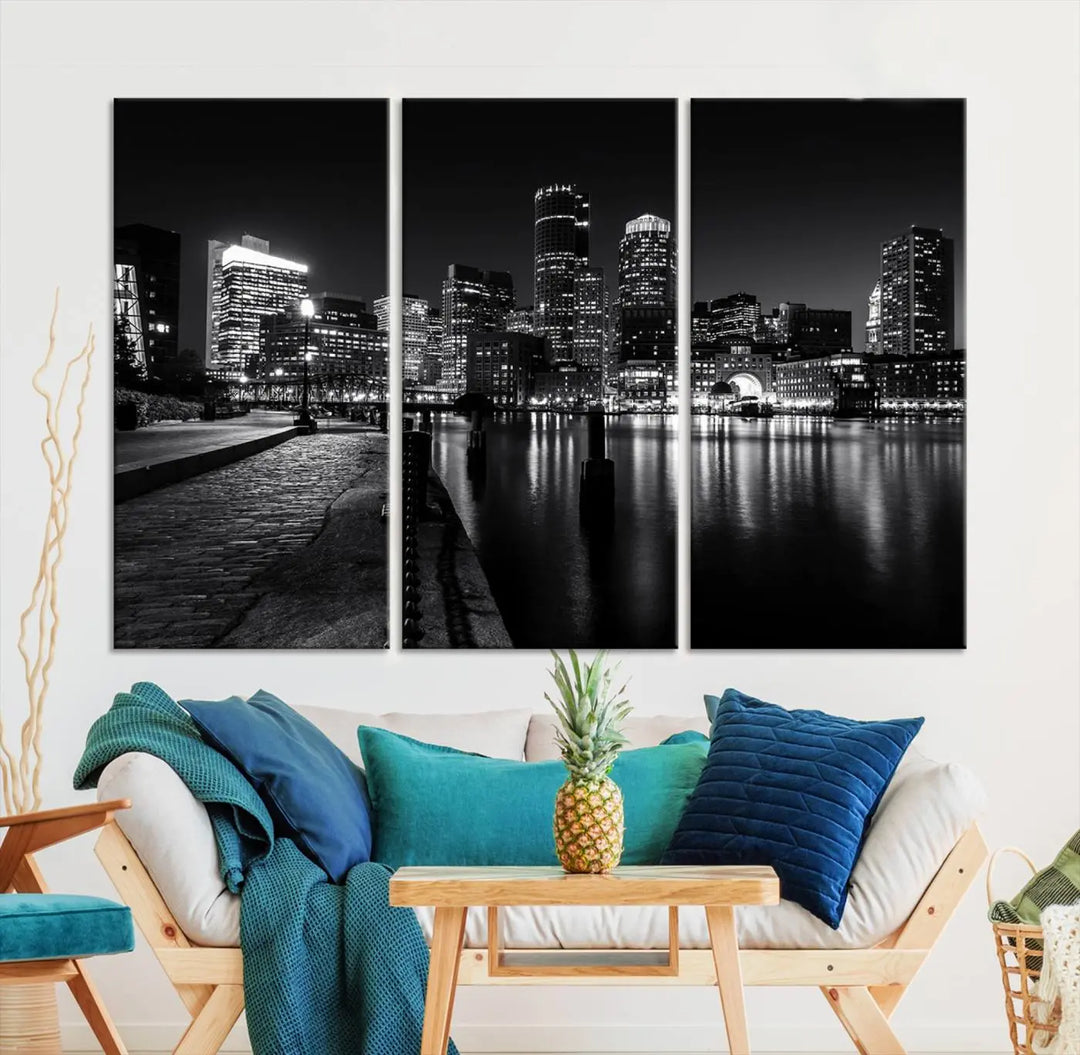 The Boston City Lights Skyline Black and White Wall Art Cityscape Canvas Print portrays a triptych of the city skyline at night reflecting on a calm river. This museum-quality canvas features UV-protective finishes to preserve its timeless allure.