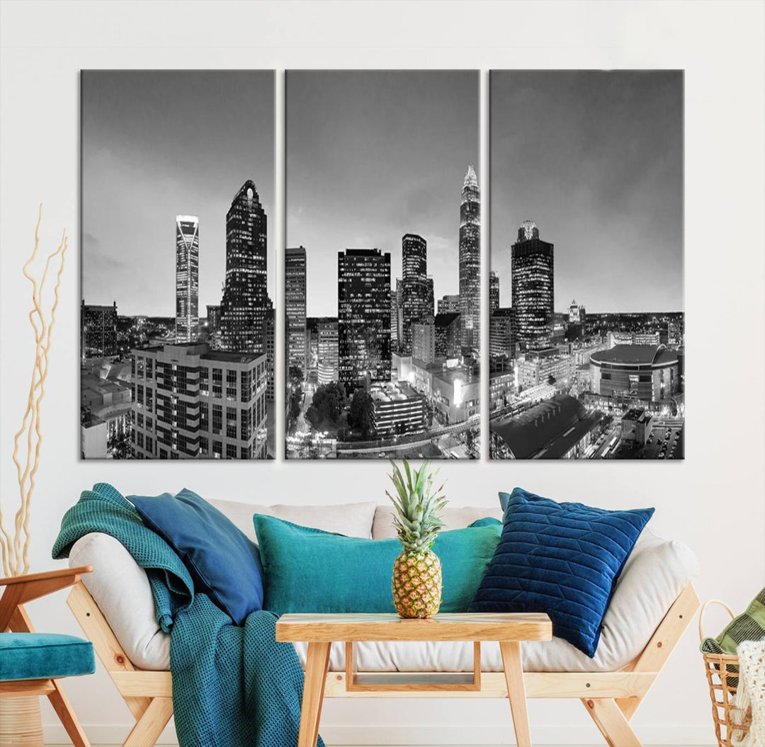 The "Charlotte City Cloudy Skyline Black and White Wall Art Cityscape Canvas Print" hangs on a dark wall, showcasing its UV-protective properties for enduring beauty.