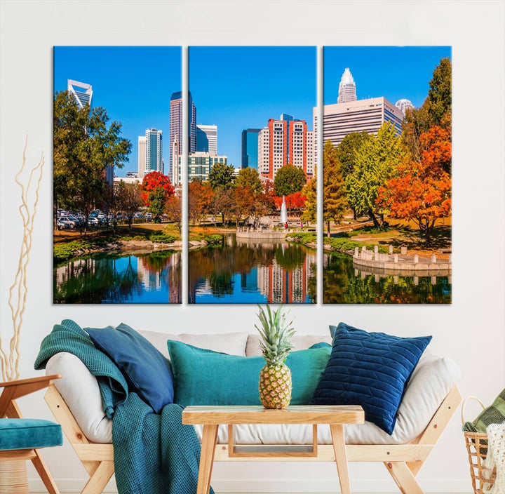 The Charlotte City Park at Fall Skyline Cityscape View wall art canvas print features a city panorama with a park and lake accented by autumn trees. It is mounted on museum-quality canvas with UV-protective coating and decorates the space.